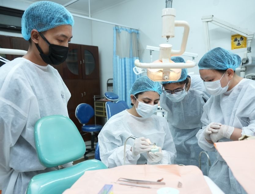 Dentists training on a patient at The Academy of Dental Excellence, New Delhi